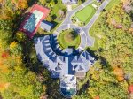A birds eye view of the property showing the main house, the guest house, and the tennis house connected to the tennis court.
